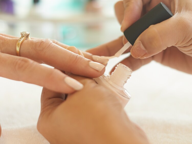 Beautician painting guest nails