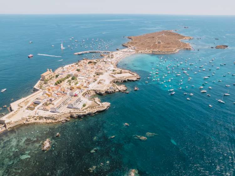 Aerial view of Tabarca island with boats at anchor. Mediterranean Sea. Popular travel destinations at summer. Spain.