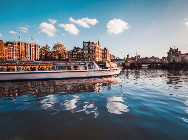 Cruising and sightseeing along Amstel canals on the water in Amsterdam, Netherlands