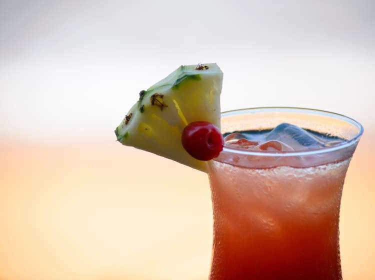 Close-up of Tequila Sunrise cocktail by the beach