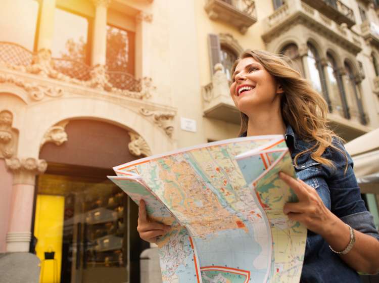 Mid age woman traveling, holding map. Europe, Barcelona.