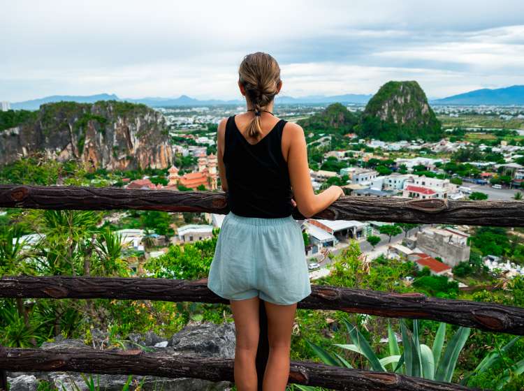 Young woman admiring the view over the city of Da Nang in Vietnam from a viewpoint.