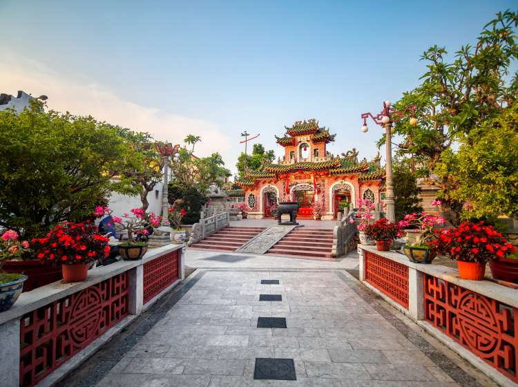 Picture shows the outdoor entrance hall and the ornated red and pink portico of the Phuc Kien Assembly Hall. It is one of the five Chinese assembly hall of Hoi An and the most visited one. It is located in the Tráº§n PhÃº street, in the heart of the medieval old town, classified as an UNESCO World Heritage Site since 1999. The Phuc Kien assembly hall was built by Chinese merchants from Fujian in 1697 and was mainly used to worship their goddess Thien Hau. The temple has a typical Fujian architecture and an ancient chinese design construction.