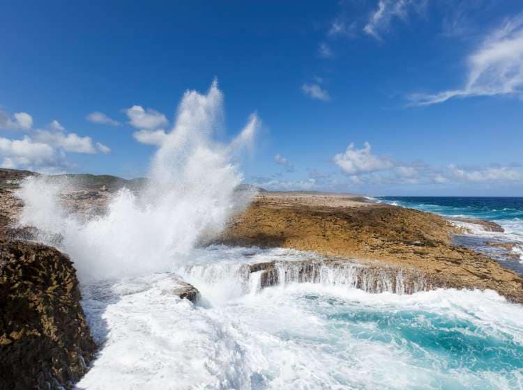 Waves crashing into Boka Pistol bay at Shete Boka National Park Curacao