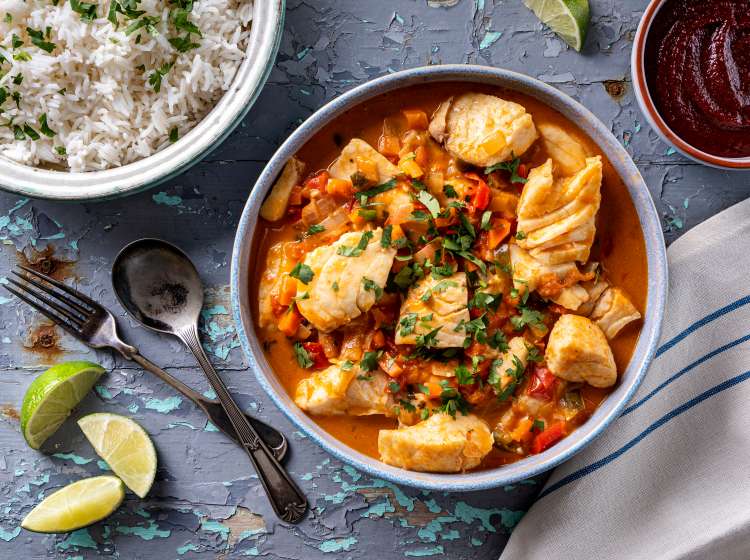 Delicious Brazilian fish stew moqueca with tomato, lime, red pepper, coconut milk and cilantro.; Shutterstock ID 1982584925; po: -; email: -
