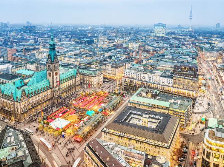 Aerial view on the winterly illuminated city of Hamburg. Christmas decoration, illuminated buildings and streets, the christmas market at the town hall.