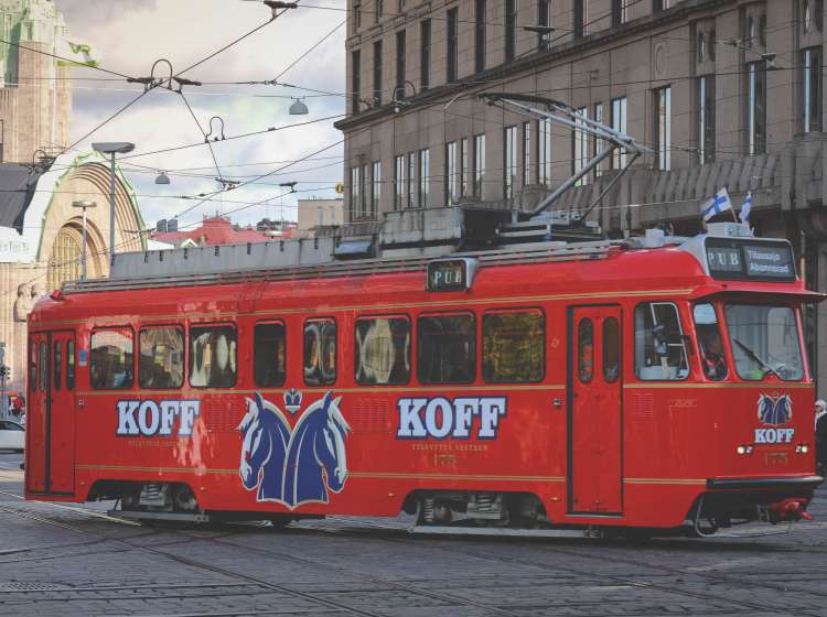 Helsinki, Finland - October 5, 2019 : Red tram transporting people in the central part of the Helsinki city, Finland
