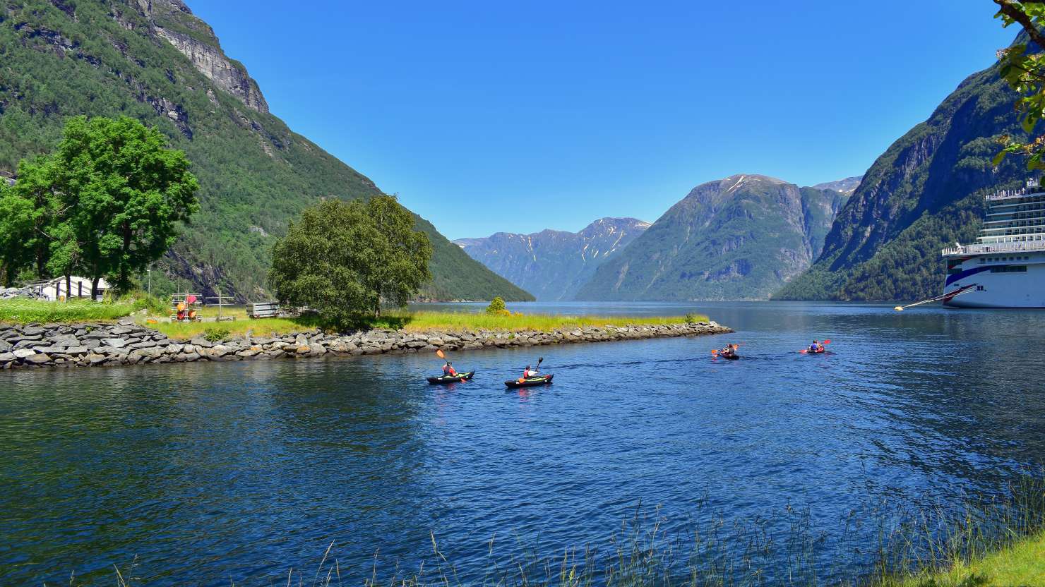 Kayaking in scenic mountains and fjord lake nature landscape near famous Geirangerfjord, Hellesylt, Norway, Scandinavia, Europe