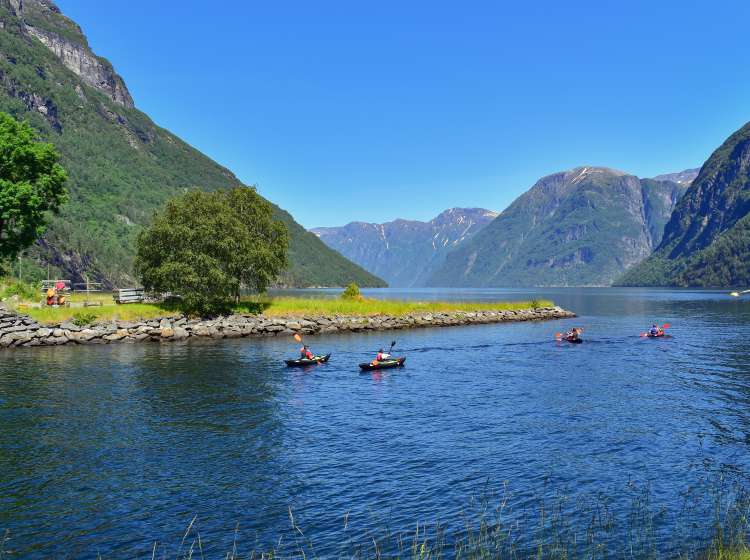Kayaking in scenic mountains and fjord lake nature landscape near famous Geirangerfjord, Hellesylt, Norway, Scandinavia, Europe