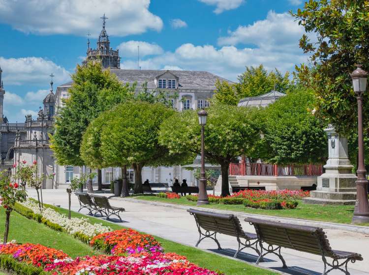Beautiful gardens of Lugo's main square during the summer, Spain. With edited sky