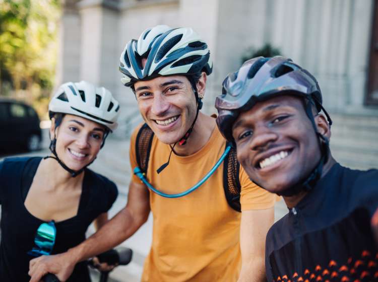 Group of  young friends traveling by bike and taking selfies in front of a Cathedral in Petropolis, Rio de Janeiro, Brazil