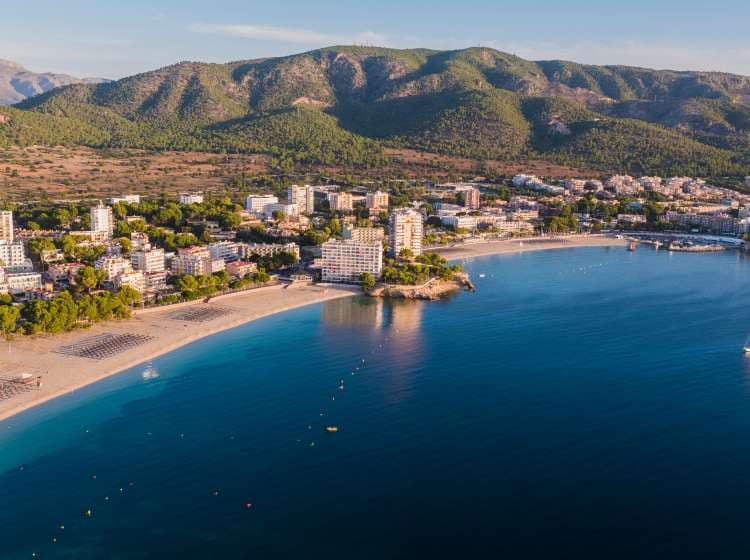 Aerial drone view of the beautiful Mallorca town of Palmanova at the sunset hours of the day. Popular tourist resort within the island.
