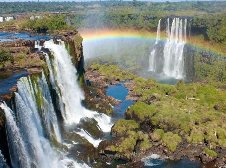 IguazÃº Falls, Iguassu Falls, or IguaÃ§u Falls are waterfalls of the Iguazu River located on the border of the Brazilian state of ParanÃ¡ and the Argentine province of Misiones. The falls divide the river into the upper and lower Iguazu. Their name comes from the Guarani or Tupi words y (water) and Ã»asÃº (big).The waterfall system consists of 275 falls along 2.7 kilometers (1.67 miles) of the Iguazu River. Some of the individual falls are up to 82 meters (269 ft) in height, though the majority are about 64 metres (210 ft). The Devil's Throat, a U-shaped, 82-meter-high, 150-meter-wide (269 by 490 feet) cataract, is the most impressive of all, and marks the border between Argentina and Brazil. Two thirds of the falls are within Argentine territory. Only two other waterfalls can be compared to the magnitude of IguazÃº. Victoria Falls in Africa and Niagara Falls on the border of the USA and Canada. IguazÃº is the widest and Victoria is the highest among these three and the two have similar annual peak flow and records well in excess of 12,000 mÂ³/s! And about Niagara, well let's just say when the former first lady of the USA visited IguazÃº, she apparently said: "Poor Niagara!"Ps.: These pictures were taken during a drought in the region and the actually amount of water is about 30% of what it usually is!