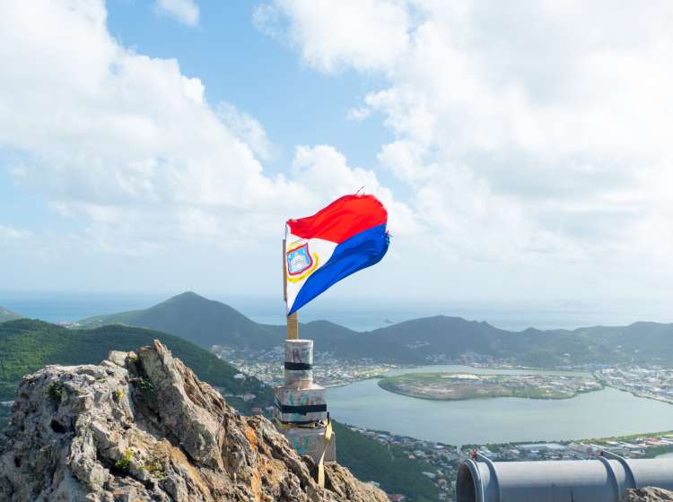 St.Maarten's flag hangs on top the highest hill on st.maarten overlooking the island landscape. ; Shutterstock ID 751316635; Invoice Number: -