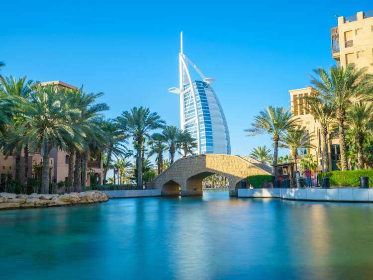 Bridge over river in front of Burj Al Arab in Dubai