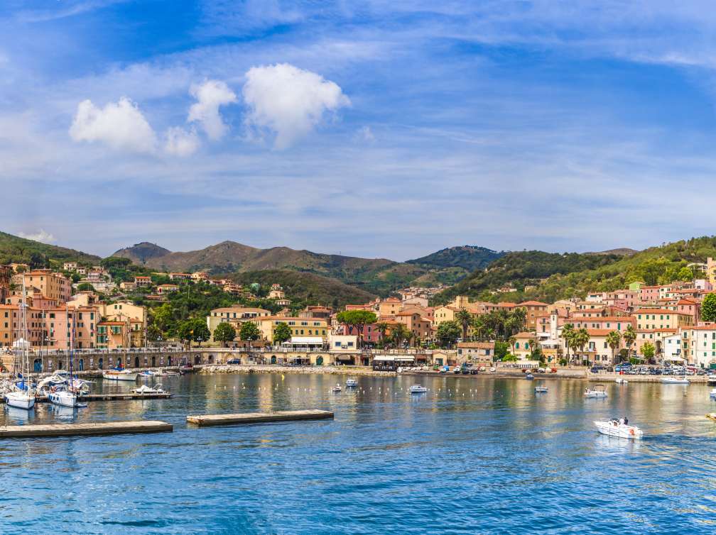 Harbour being overlooked by buildings and mountains