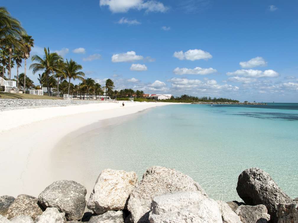 Rocks in front of a beautiful white sandy beach