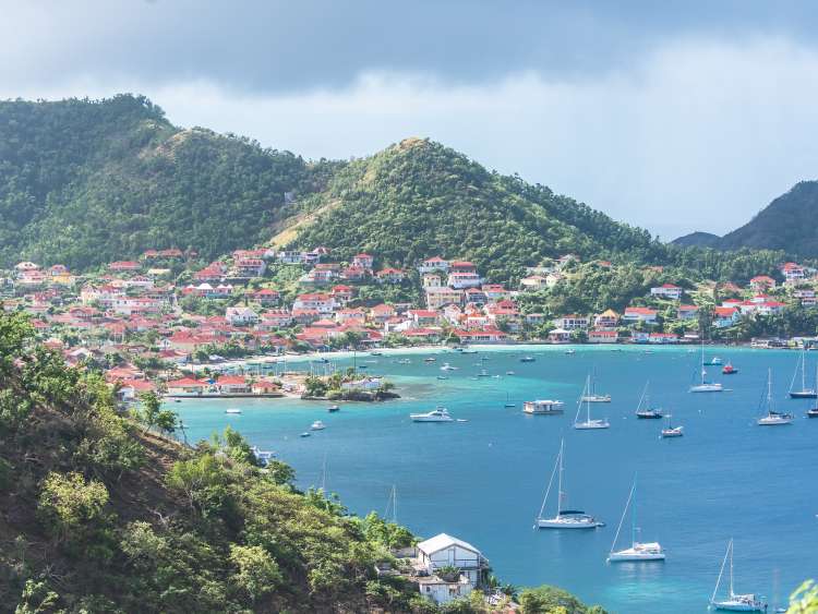 View of city in front of mountains and the sea