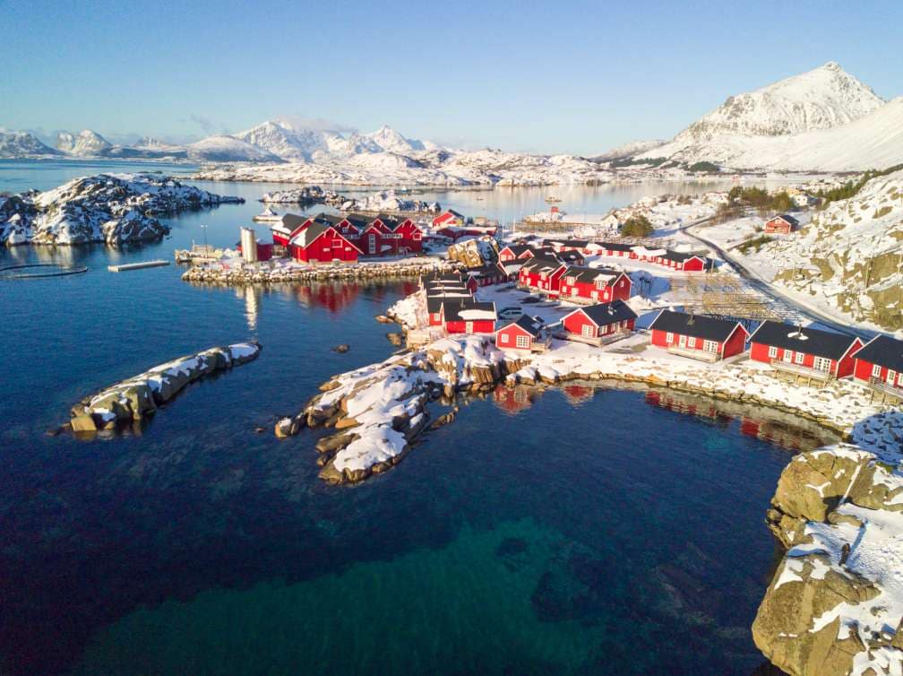  Houses and water infront of snowy mountains