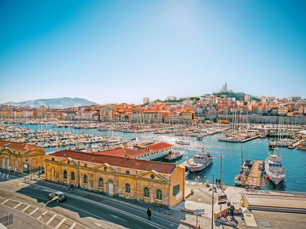 Harbour being overlooked by buildings and mountains