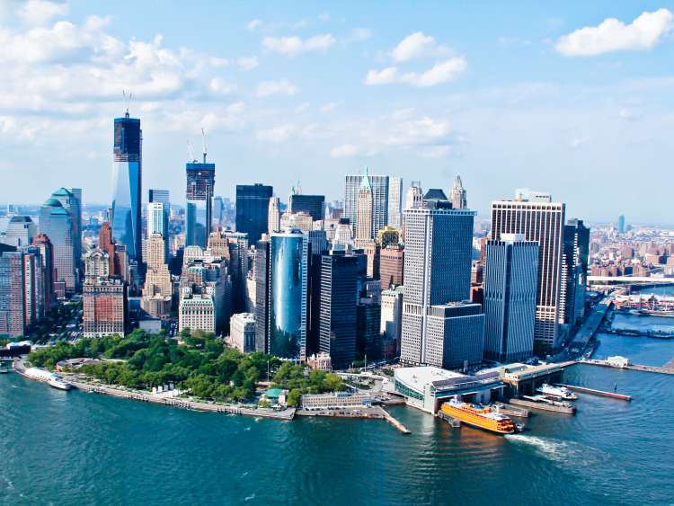 Skyline of New York City surrounded by the Hudson River 