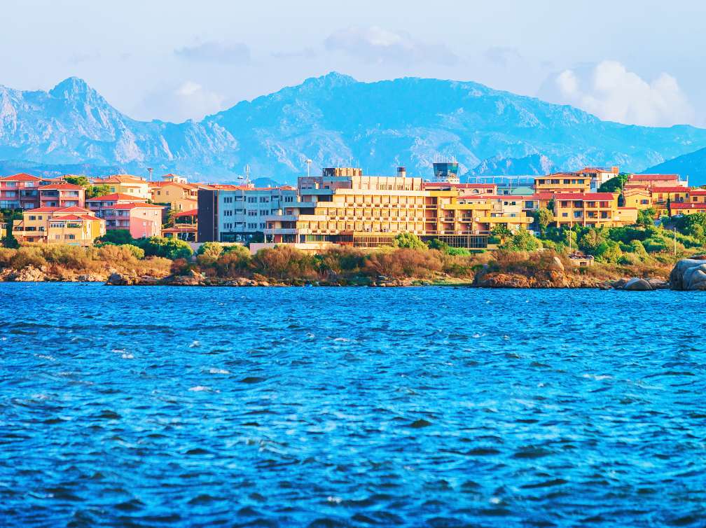Rustic buildings behind sea 