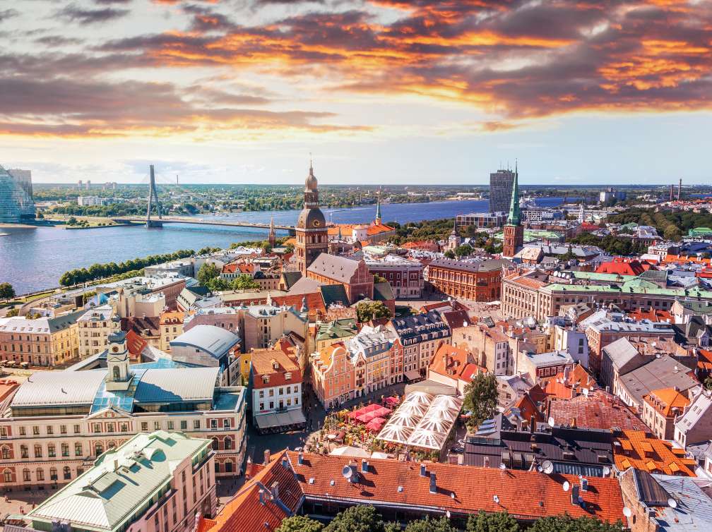  A sky view of a city of buildings by a bridge over water