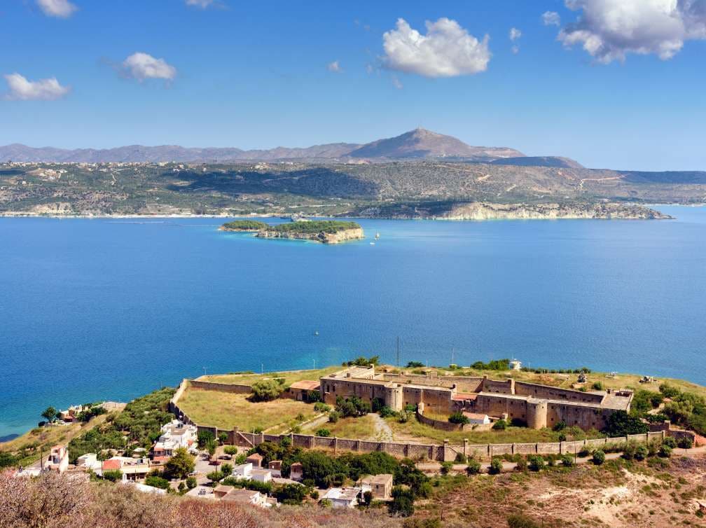 Stoney building overlooking sea and mountains