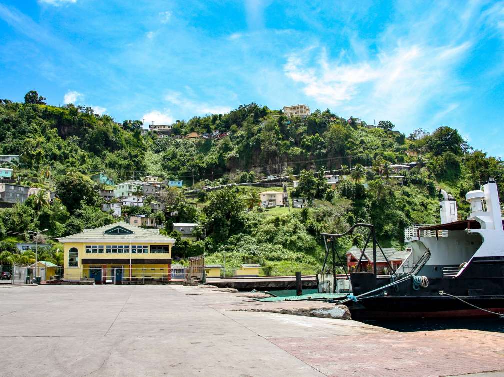 small ferry docking in by little village