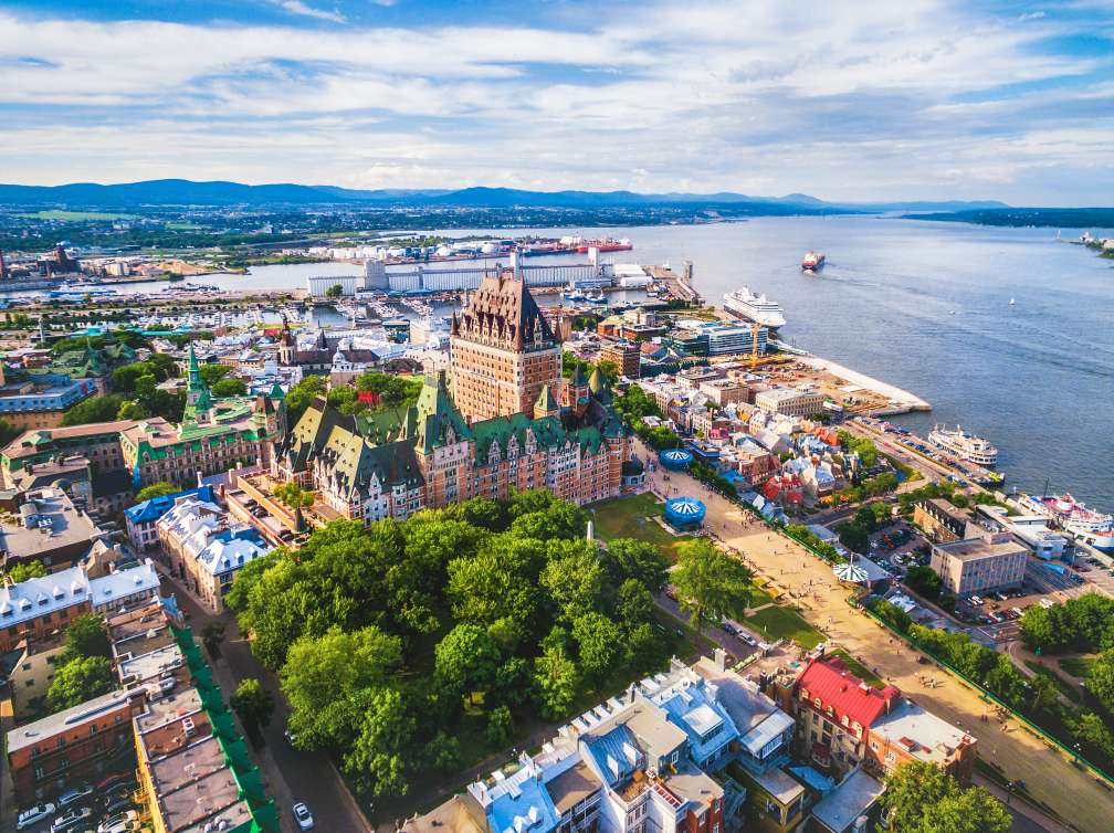 A sky view of a city of buildings by the sea