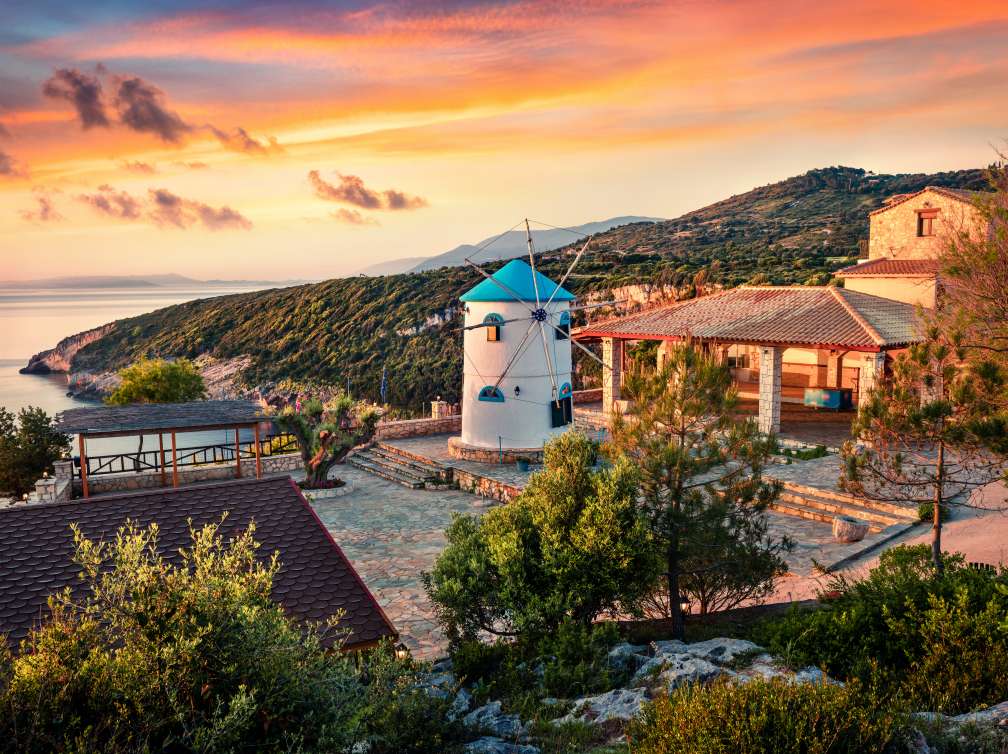 Windmill and house overlooking the sea