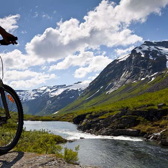 Biker next to a river in Norway