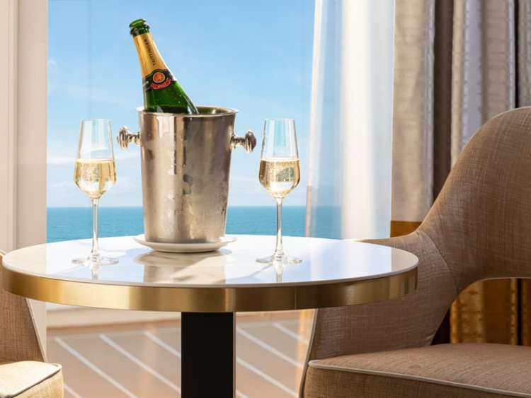 Champagne glasses and bottle on table in suite on Iona