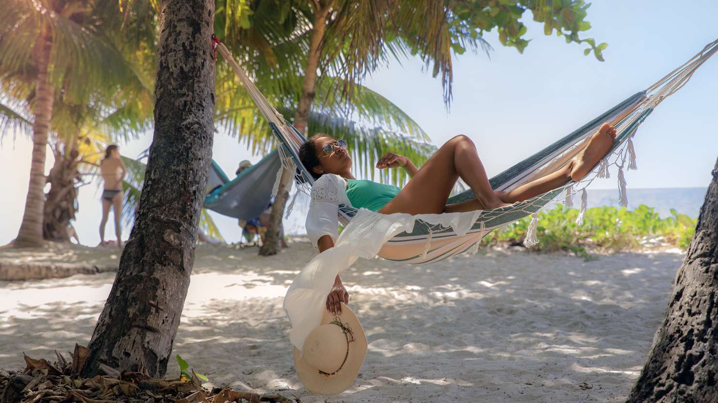 Woman in hammock on Caribbean beach