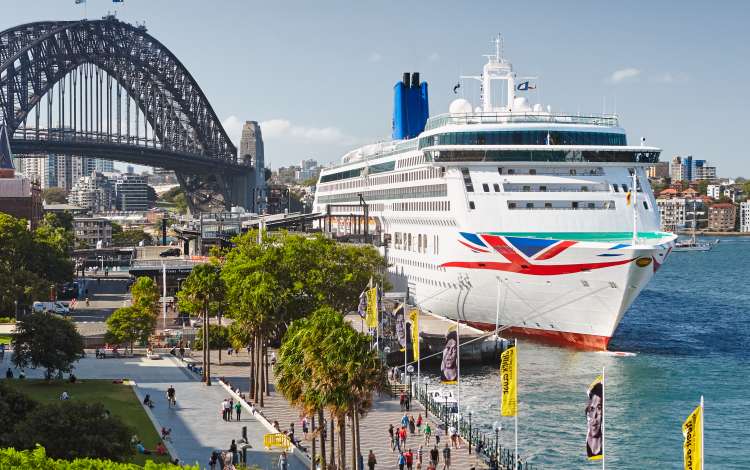 Aurora docked next to the Sydney Harbour Bridge