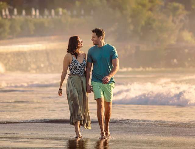 Couple walking along the beach together