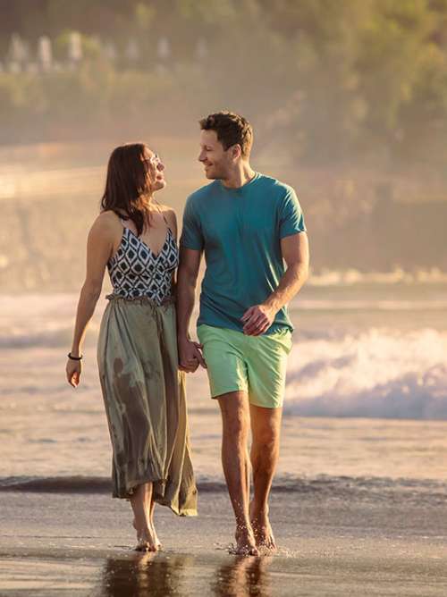 Couple walking along the beach together