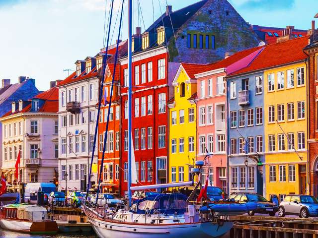 Image of buildings next to harbour by the sea