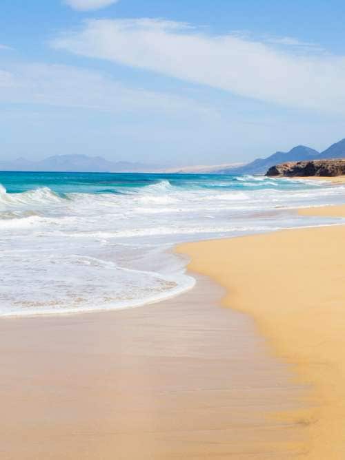 A sandy beach with blue water