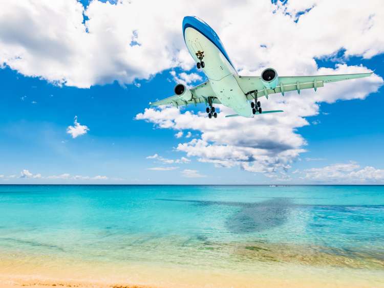Plane flying over beach in St Maarten