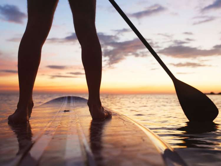 Person paddle-boarding in the sea