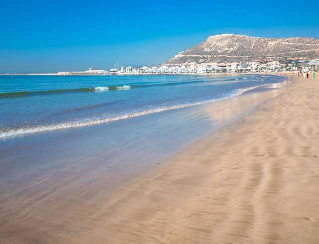 Agadir beach on the Atlantic African coast in the summertime with yellow sand and turquoise water in Morocco