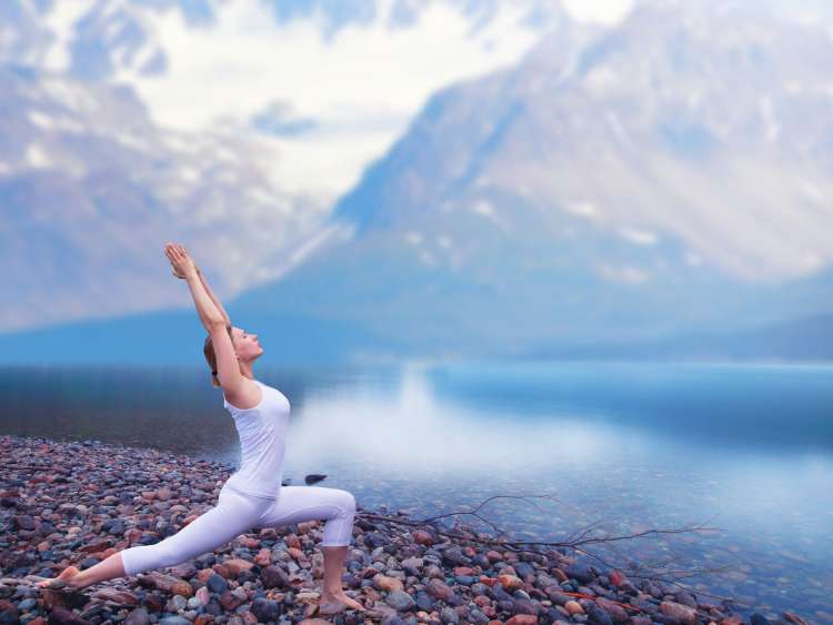 Woman doing yoga on rock in Norway