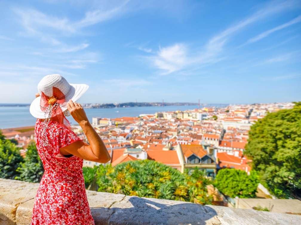 Women in hat exploring Lisbon, Portugal