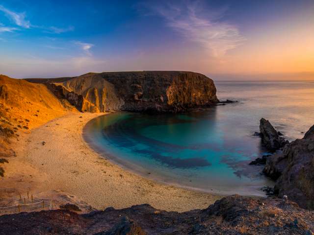 Romantic sunset over the beautiful, natural and sandy beach of Papagayo on Lanzarote; Shutterstock ID 1401796853; Project: Adobe