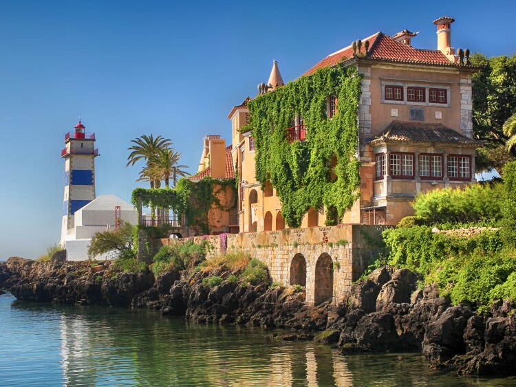  A building and lighthouse by water
