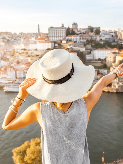 Lady pointing at Dom Luis I Bridge in Porto