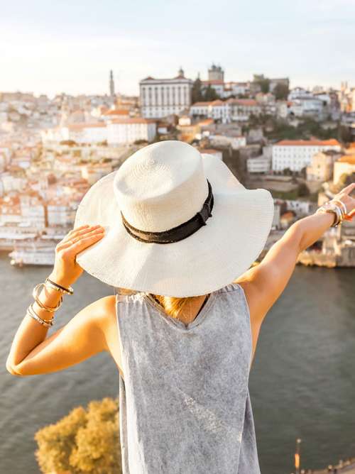 Someone with a hat on infront of Spain skyline