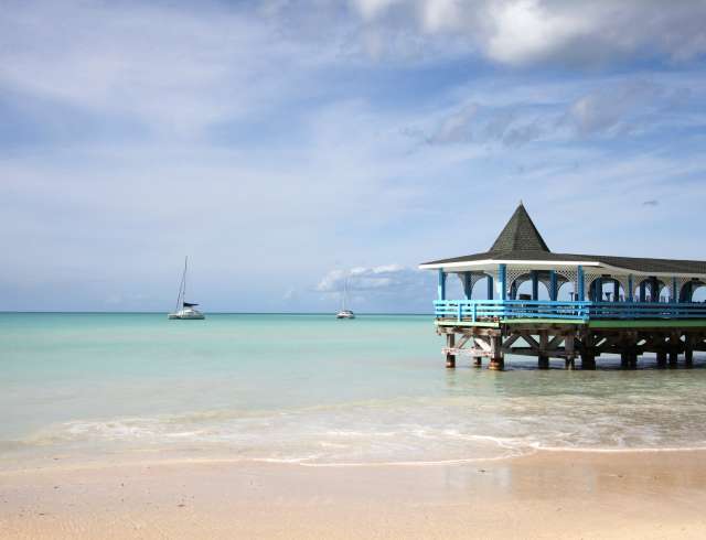 Beautiful day with a view out to sea & the pier of Runaway Beach, Antigua, Caribbean.; Shutterstock ID 552286777; project: Caribbean beaches page; job: new page; client: PO Cruises; other: 