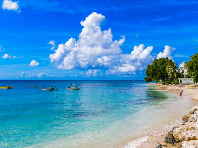 Boats in the water at a beach in Bridgetown, Barbados